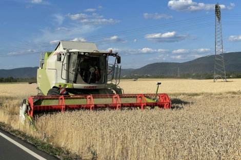a-large-green-and-white-combine-in-a-field.jpg a large green and white combine in a field